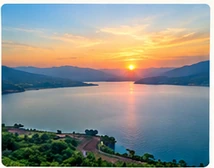 Sunset over the dam shown in the supplied reference image