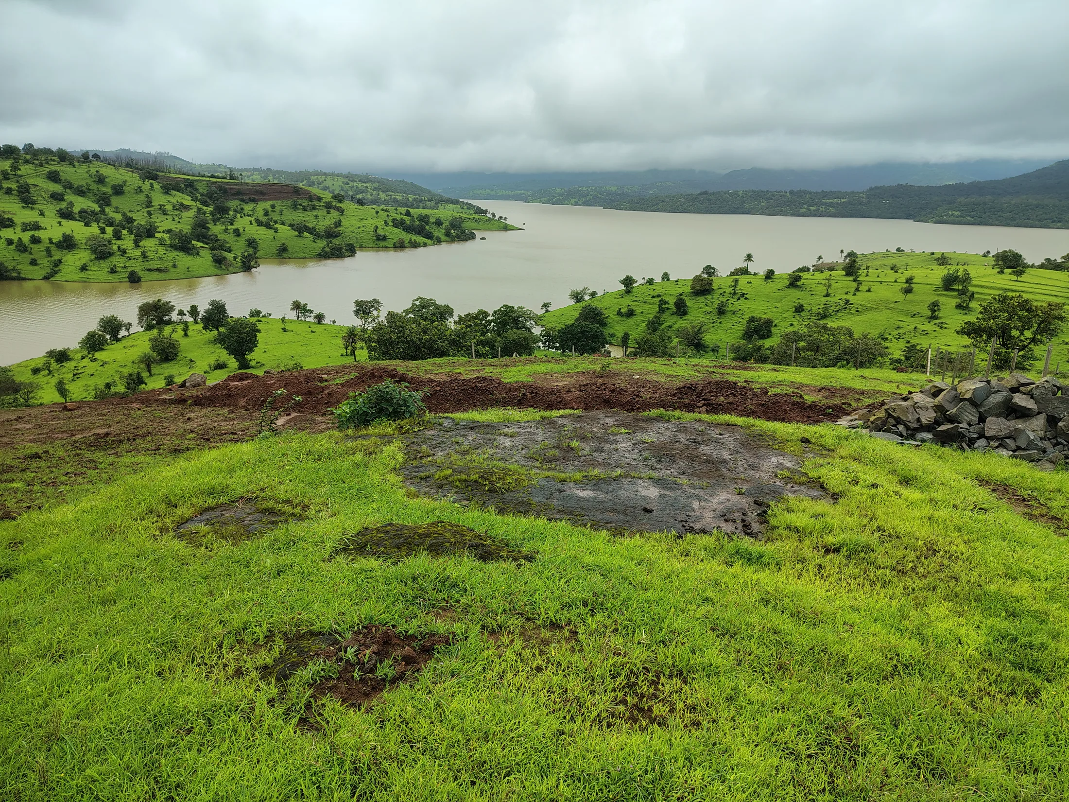 Expansive dam and hillside view from the site